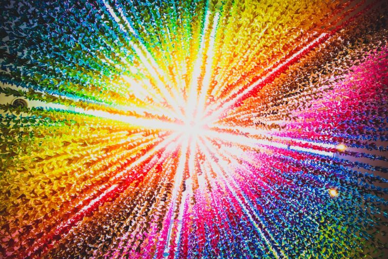 a multicolored burst of light in the middle of a black background